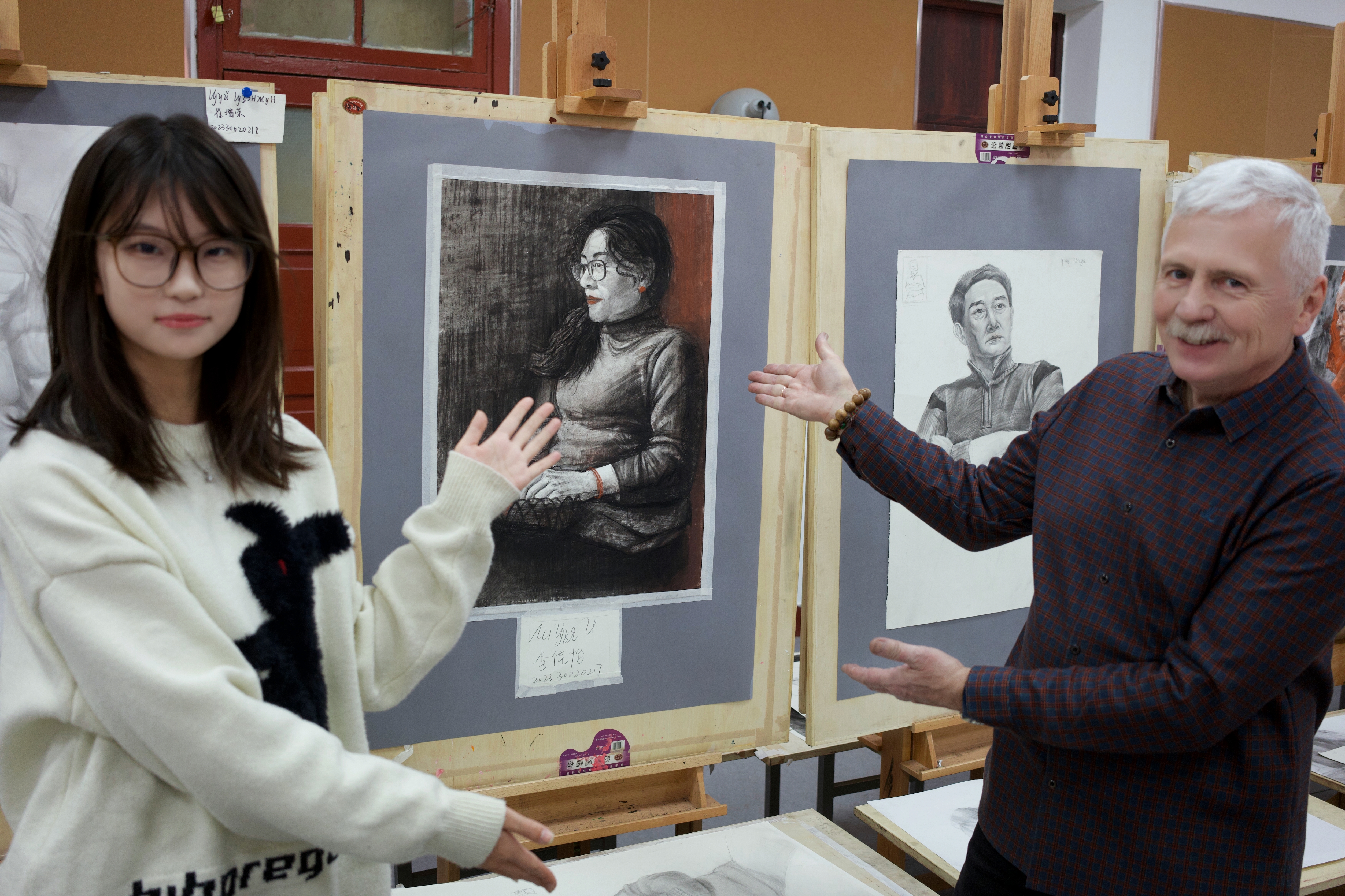 Playful photo with Андрей beside drawings